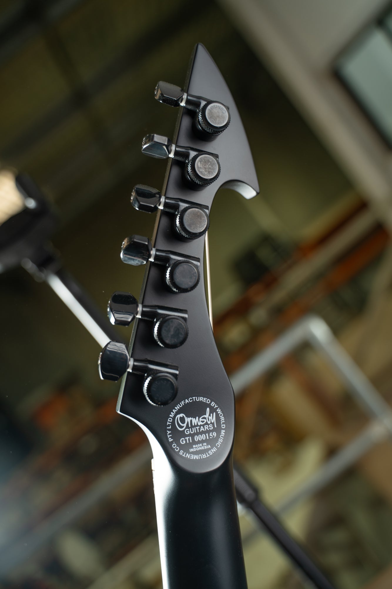 Close-up of a guitar's tuning pegs with a blurred background